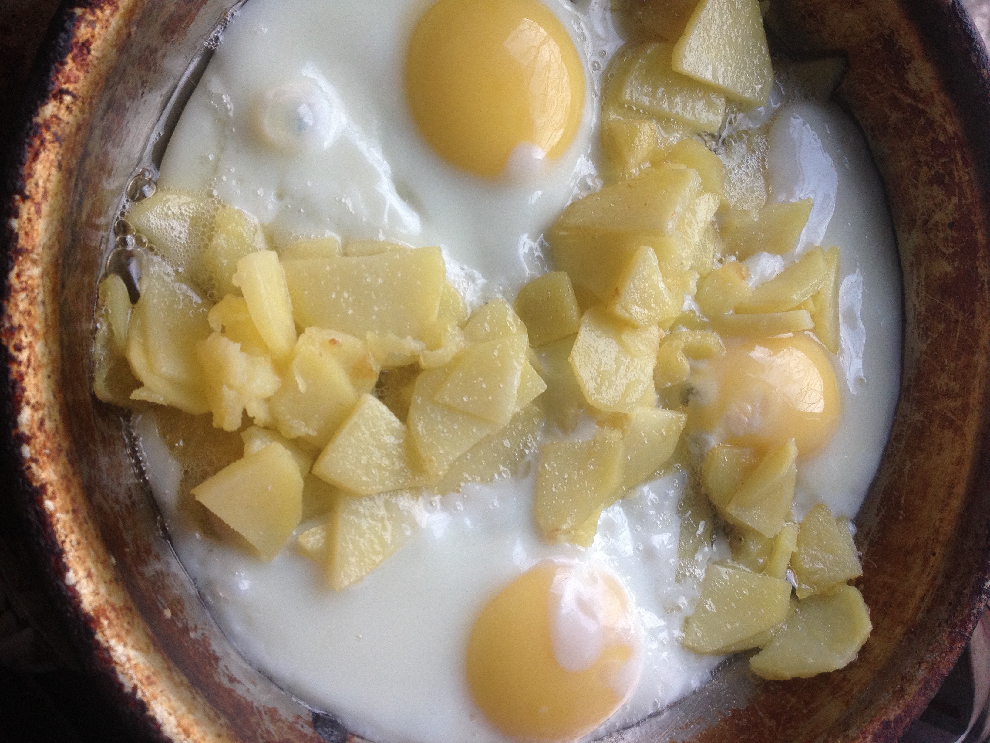Frying eggs and potato